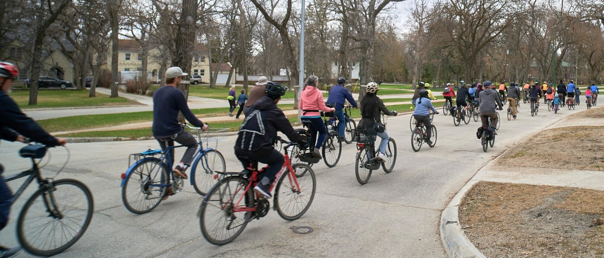 Group of people on bicycles riding on the streets of downtown Winnipeg