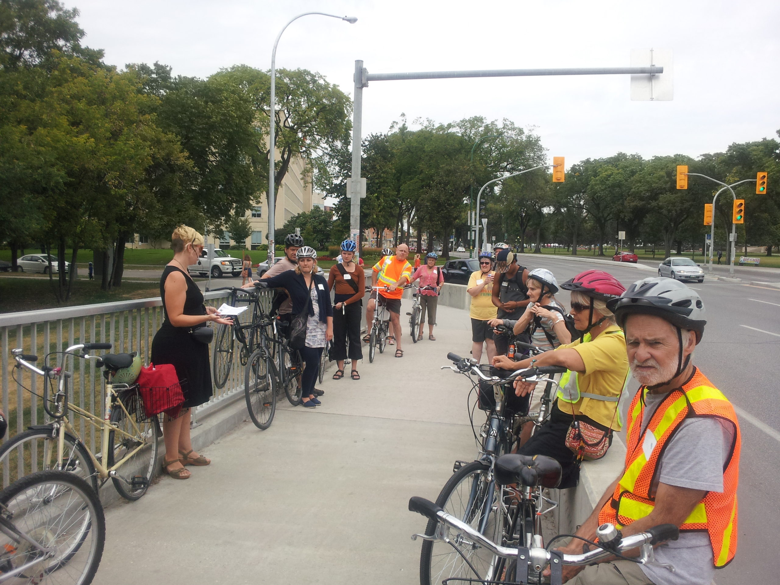 Cyclists learn about "From Here Until Now", a public art piece on the Osborne Bridge